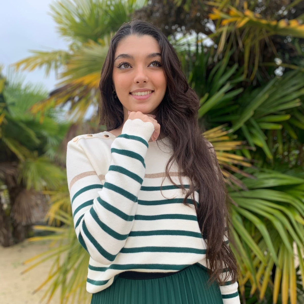 Women's striped knit sweater with a crew neck and shoulder buttons