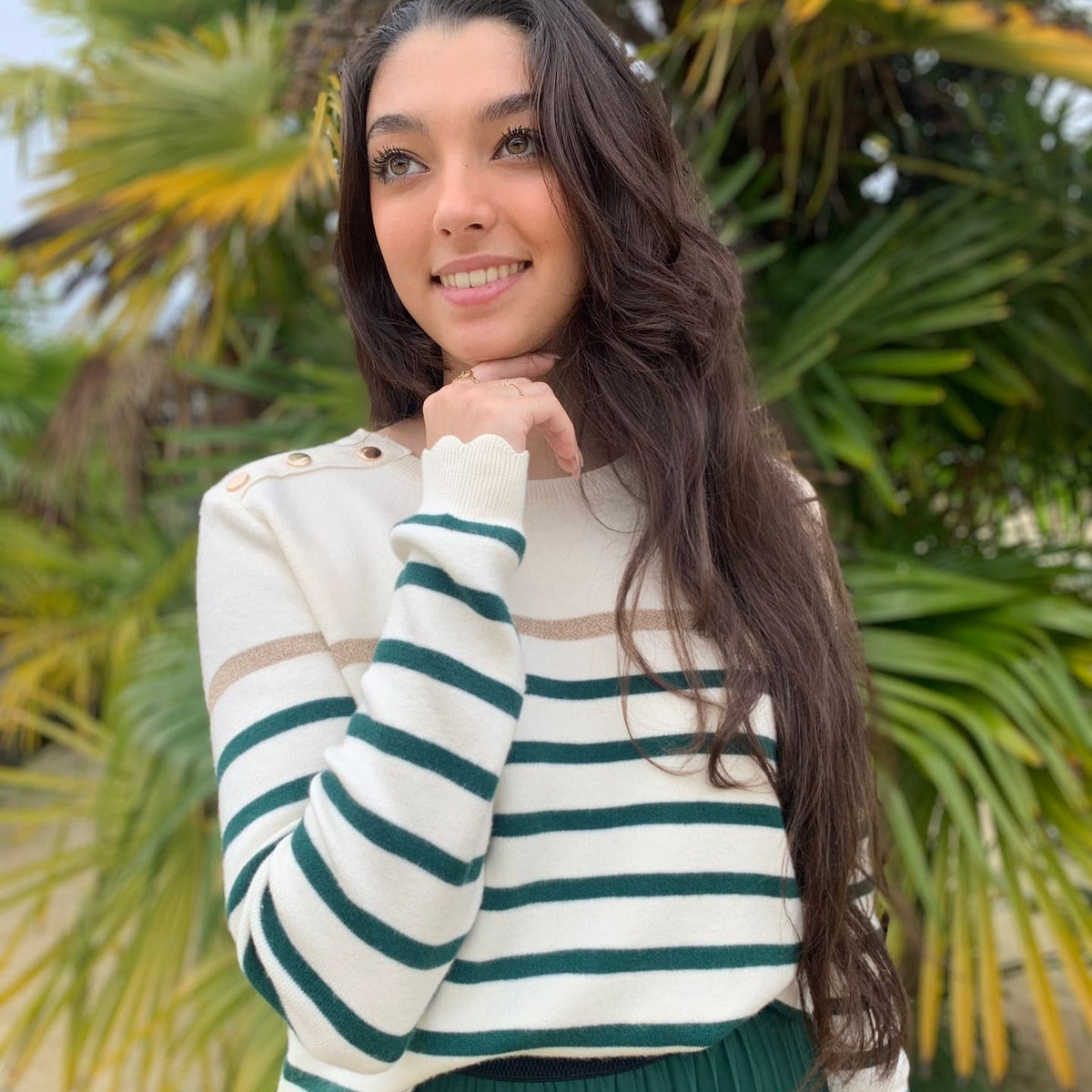 Women's striped knit sweater with a crew neck and shoulder buttons