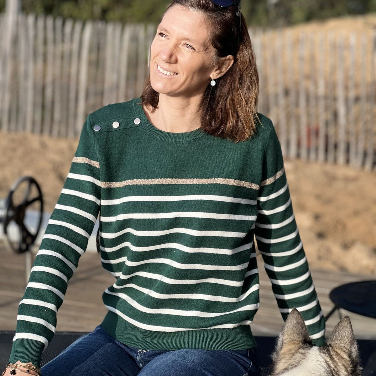 Women's striped knit sweater with a crew neck and shoulder buttons