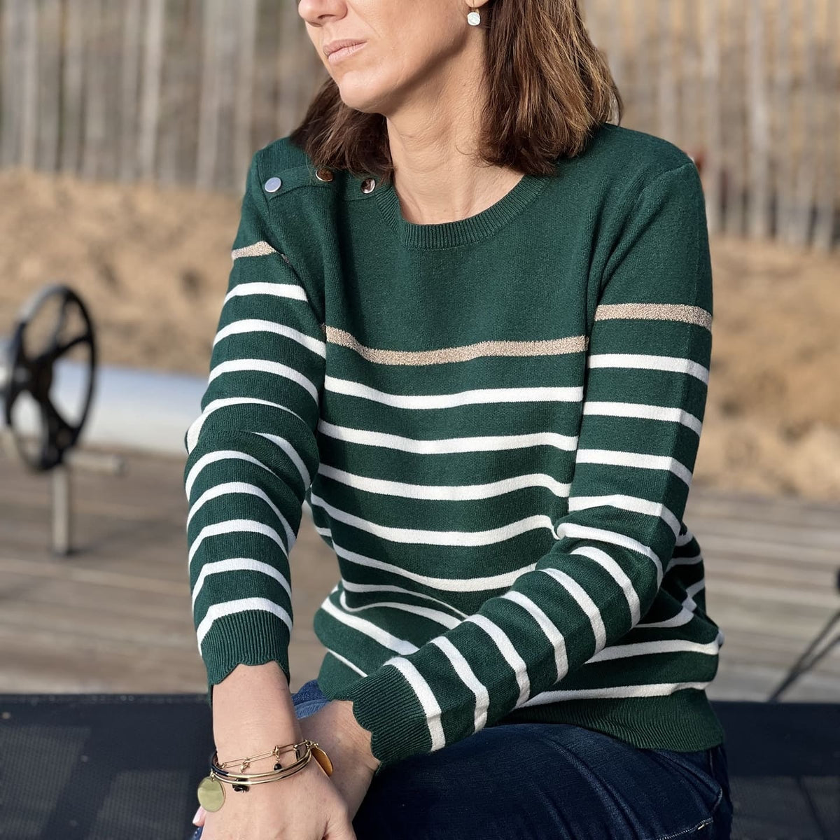 Women's striped knit sweater with a crew neck and shoulder buttons