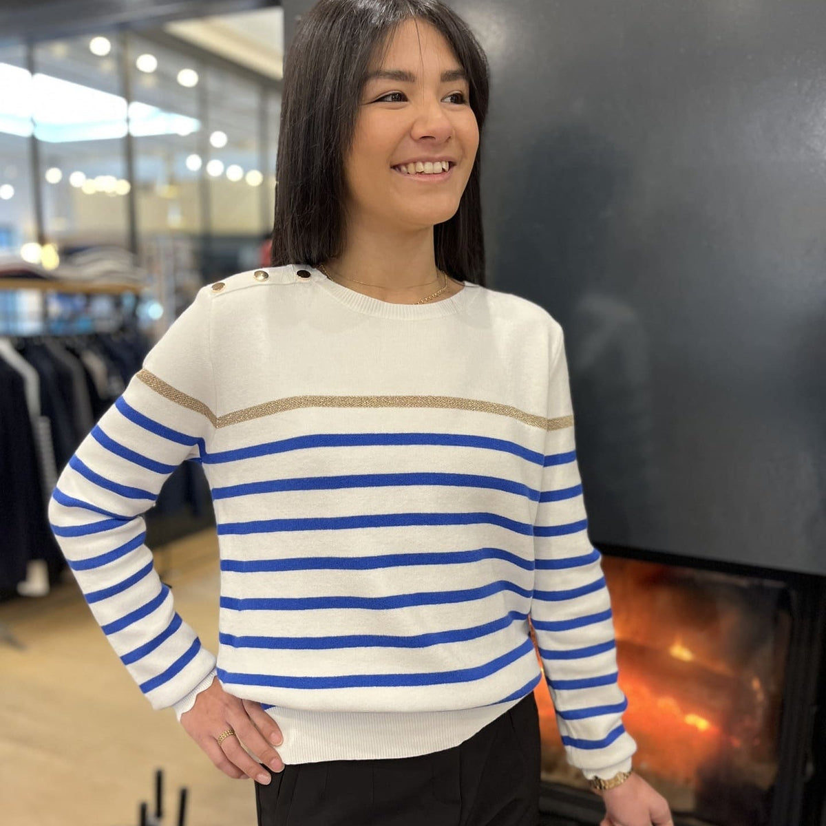 Women's striped knit sweater with a crew neck and shoulder buttons