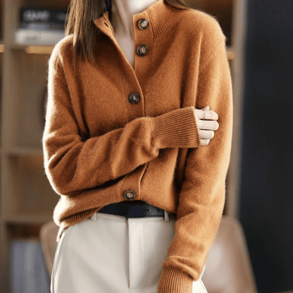 Maglione marrone in cashmere con bottoni, indossato da una donna in pantaloni chiari. Moda autunnale elegante e calda.