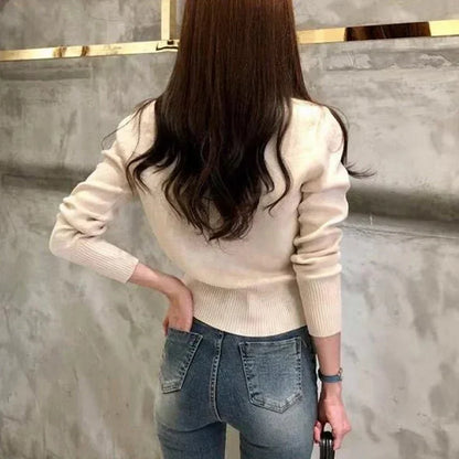 Women's fitted knit cardigan with a high collar, button closure, and long sleeves
