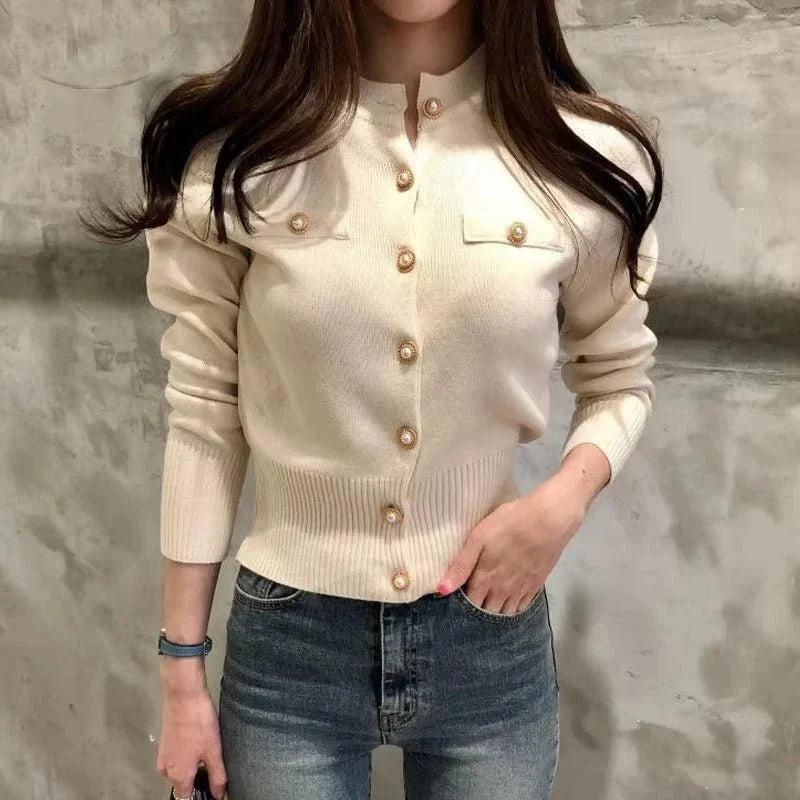 Women's fitted knit cardigan with a high collar, button closure, and long sleeves
