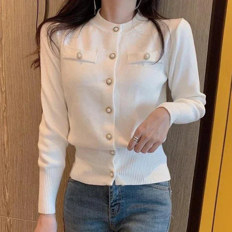 Women's fitted knit cardigan with a high collar, button closure, and long sleeves